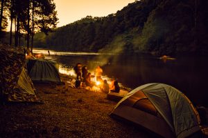 Group,Of,Backpackers,Relaxing,Near,Campfire,,Tourist,Background.